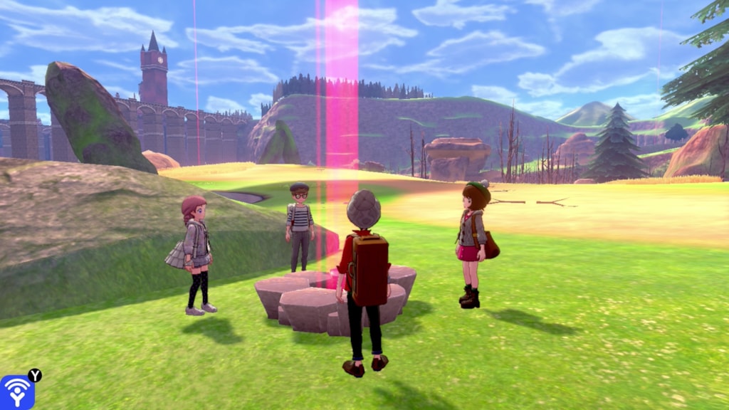 Trainers gather around a raid den in the wild area in Pokémon Sword and Pokémon Shield.